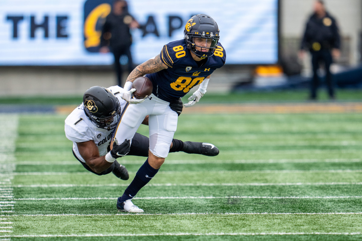 California Golden Bears wide receiver Trevon Clark (80) runs after the catch for the first down and is tackled by Colorado Buffaloes linebacker Guy Thomas (1).